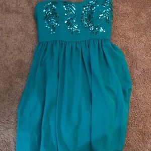 Small, teal strapless dress with detail